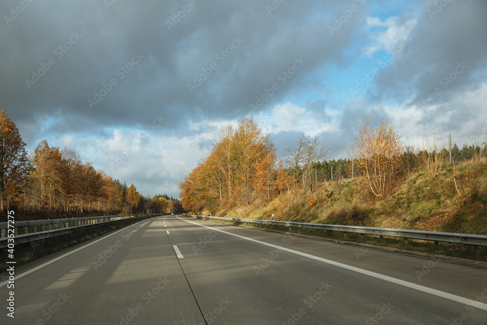 Car is driving on the highway. Autumn mood on the highway