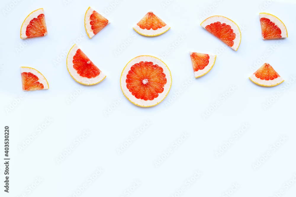 Fototapeta High vitamin C. Juicy grapefruit slices on white.