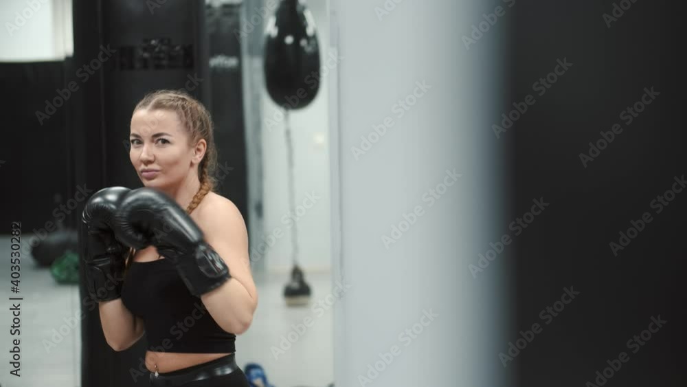 Boxing lesson.Woman athlete training kickboxing exercise workout punching bag. European. Boxing lesson.Woman athlete training kickboxing exercise workout punching bag. European.