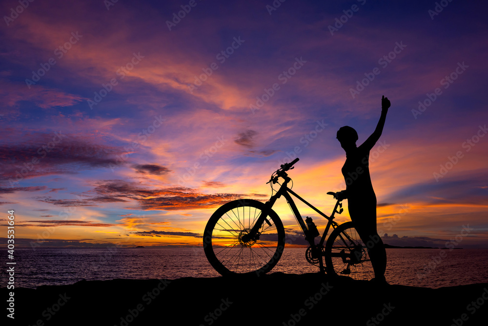 Fototapeta premium cyclist and Bicycle silhouettes on the dark background of sunsets. ride bicycle on sunset background.