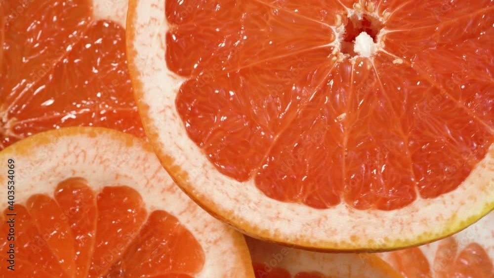 Fresh sliced orange rotating on fruit background. Top view Fresh sliced orange rotating on fruit background. Top view