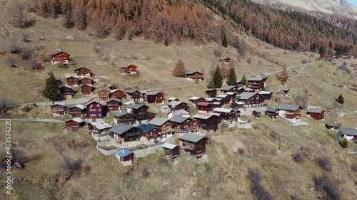 Small village in the Lötschental in autumn. There are many small huts and a chapel in the village. It is autumn and winter is coming soon photo