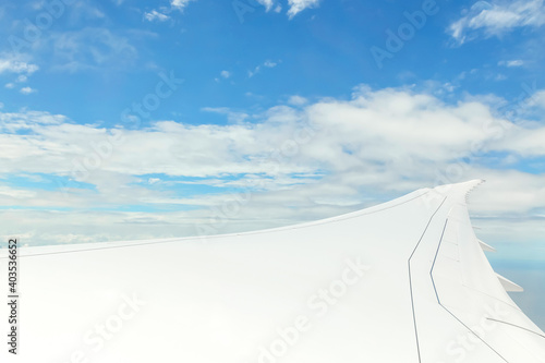 Airplane Wing in Flight from window, cloud sky