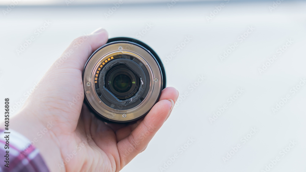 A floating lens mount on the ass in a hand holding a white background. A floating lens mount on the ass in a hand holding a white background.