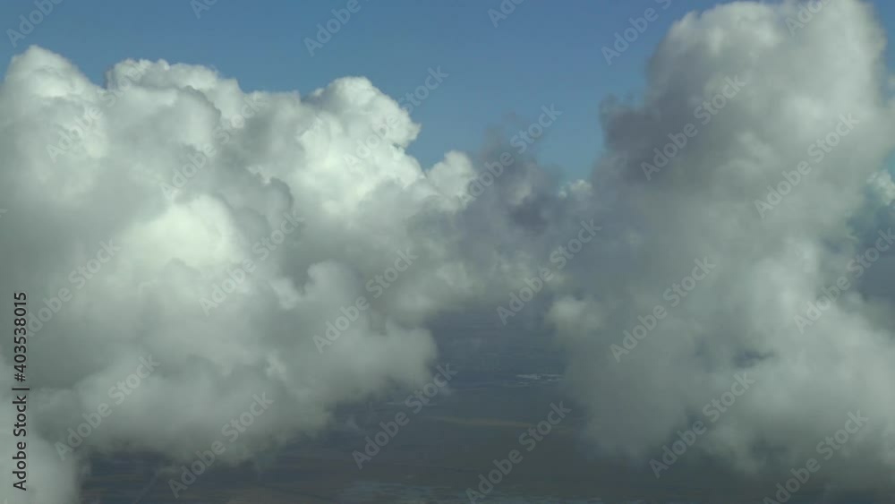 Flying around and into the clouds in a commercial airplane. Actual high altitude footage.