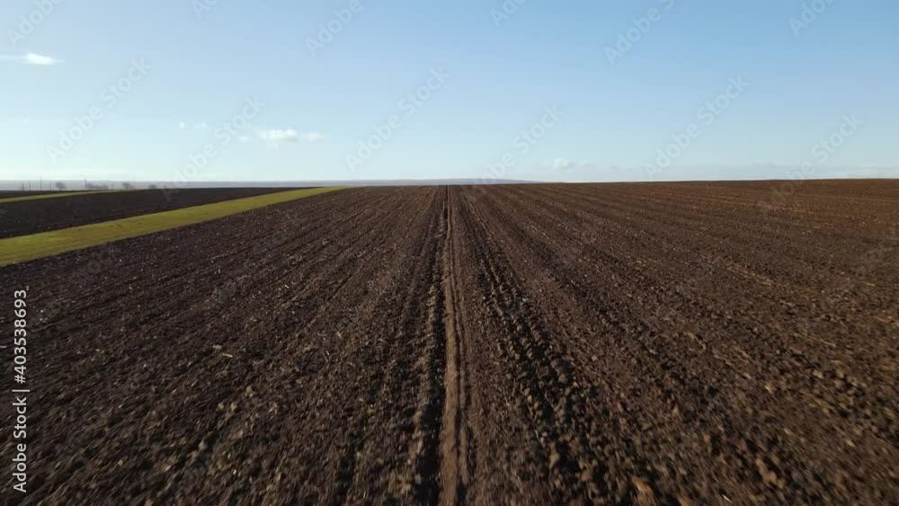 Dark brown plowed grounds of the farmlands in Vrancea, Romania - Aerial Dark brown plowed grounds of the farmlands in Vrancea, Romania - Aerial