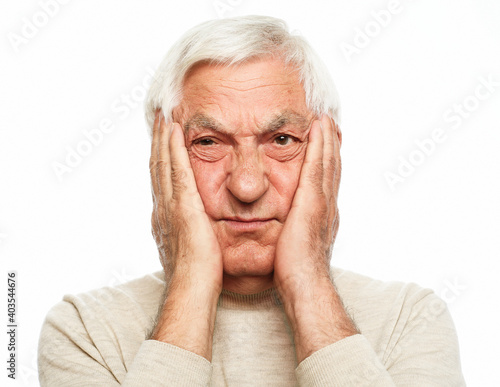 lifestyle, health and old people concept: Portrait of an old man having a toothache against white background