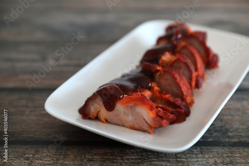 Roasted pork thai local food with red sauce on wood background