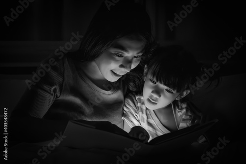 mom and daughter have goodtime reading bedtime stories for daughter photo