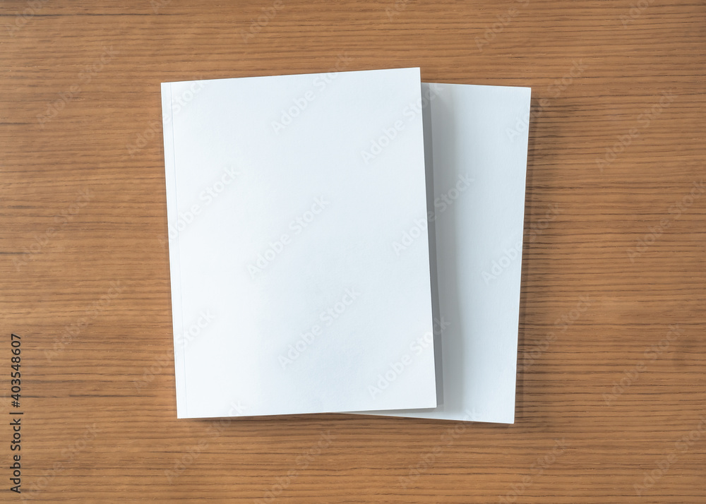Book mockup with blank white front cover page a4 paperback mock up for catalog, magazine, menu, booklet, notebook, portfolio design template on wood table background Book mockup with blank white front cover page a4 paperback mock up for catalog, magazine, menu, booklet, notebook, portfolio design template on wood table background