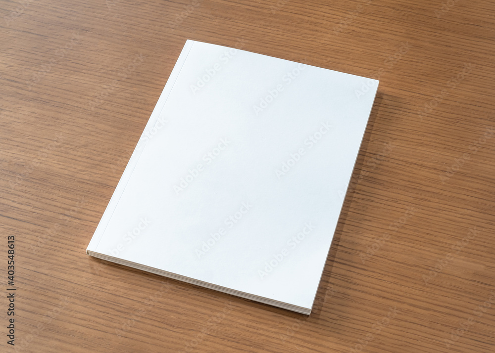 Book mockup with blank white front cover page a4 paperback mock up for catalog, magazine, menu, booklet, notebook, portfolio design template on wood table background Book mockup with blank white front cover page a4 paperback mock up for catalog, magazine, menu, booklet, notebook, portfolio design template on wood table background