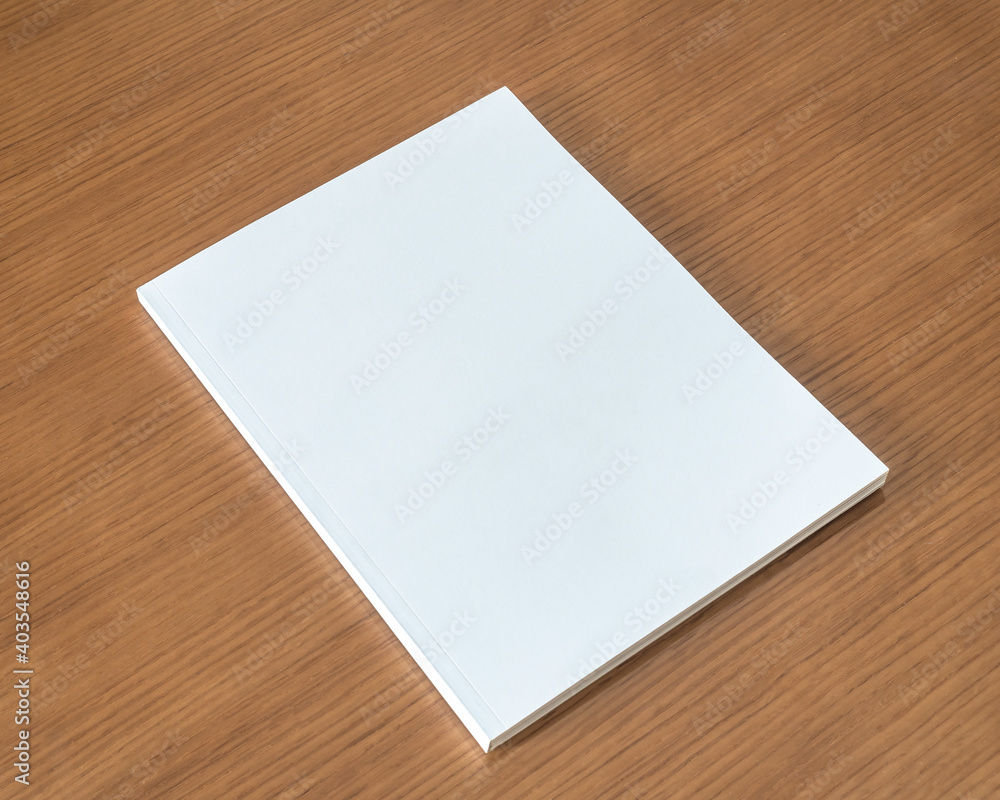 Book mockup with blank white front cover page a4 paperback mock up for catalog, magazine, menu, booklet, notebook, portfolio design template on wood table background Book mockup with blank white front cover page a4 paperback mock up for catalog, magazine, menu, booklet, notebook, portfolio design template on wood table background