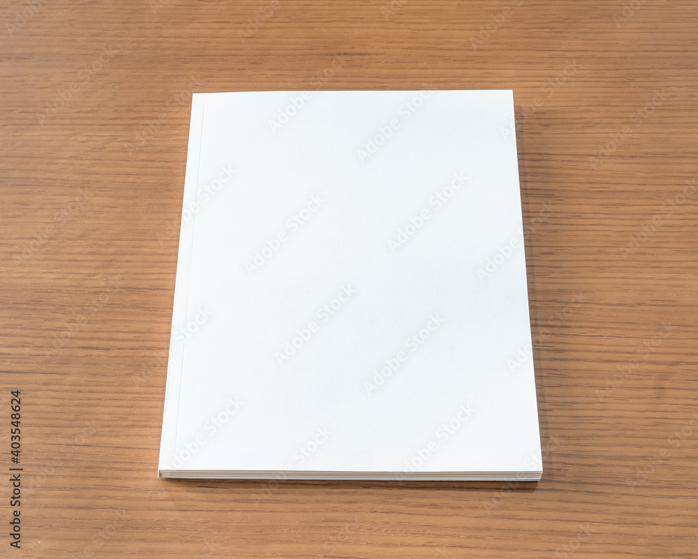 Book mockup with blank white front cover page a4 paperback mock up for catalog, magazine, menu, booklet, notebook, portfolio design template on wood table background Book mockup with blank white front cover page a4 paperback mock up for catalog, magazine, menu, booklet, notebook, portfolio design template on wood table background
