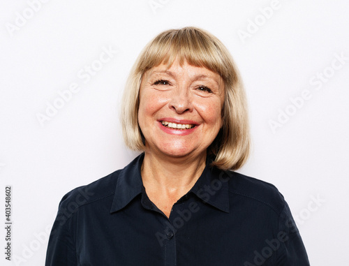 Portrait of senior woman with cute smile over white background