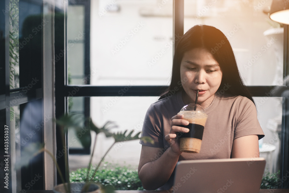 A beautiful woman working on a laptop to prevent a virus outbreak, the concept of a new normal lifestyle.
