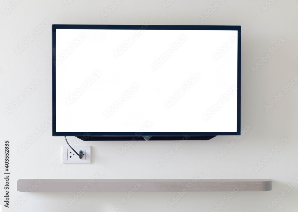 Black digital smart TV stuck on the house wall on gray background Black digital smart TV stuck on the house wall on gray background