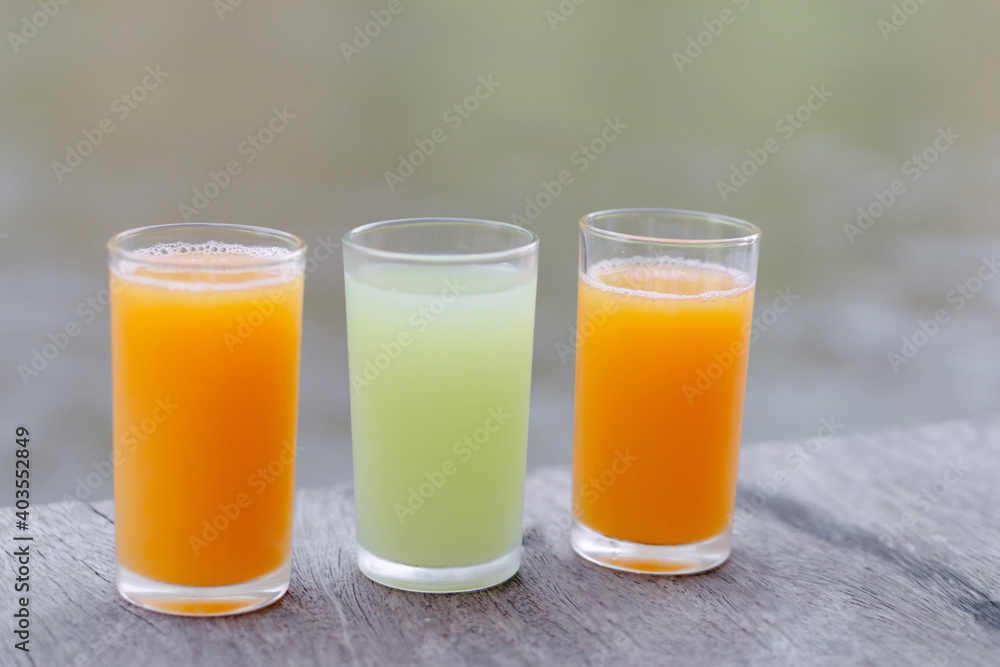 Closeup orange and guava juice on wood background, drink for healthy concept, selective focus Closeup orange and guava juice on wood background, drink for healthy concept, selective focus