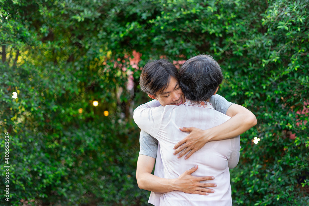 Son and mother hugging each other with love outdoors. Son and mother hugging each other with love outdoors.