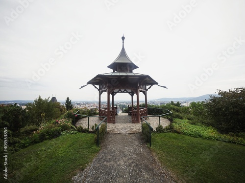 Panorama view of historic chinese pavilion on Schlossberg Castle Hill in city center Graz Styria Austria alps mountains