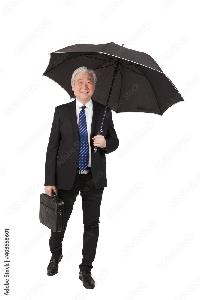 An old senior businessman with briefcase and umbrella An old senior businessman with briefcase and umbrella