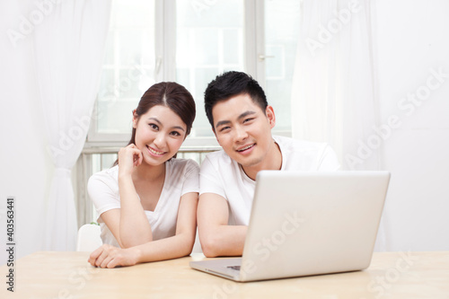 A young Couple Using Laptop at Home  © eastfenceimage