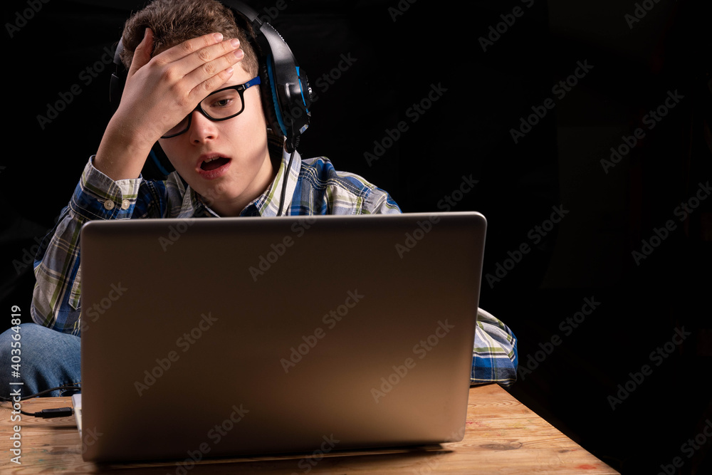 Boy doing school at home with shirt and glasses on laptop Boy doing school at home with shirt and glasses on laptop