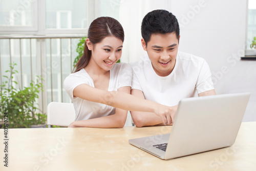 A young Couple Using Laptop at Home 