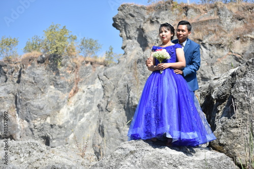 Asian wedding couple at the rocky background
