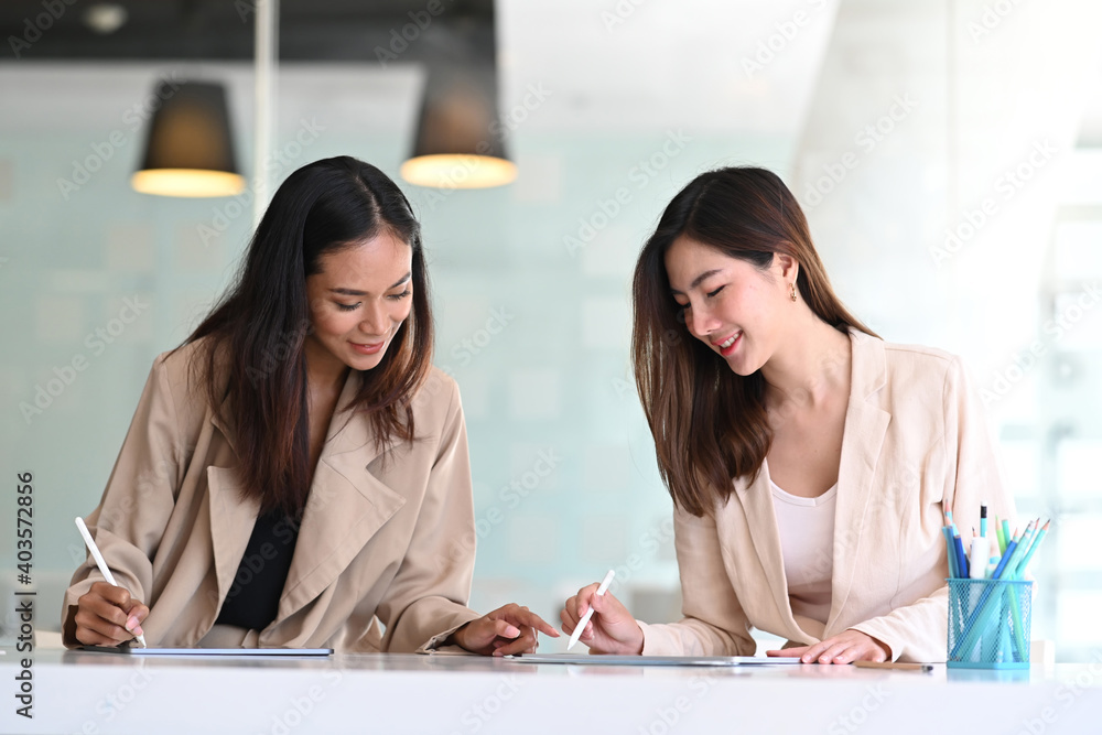 Fototapeta premium Asian business people working with digital tablet and searching data for business startup plan and strategy in modern office.