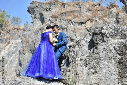 Asian wedding couple at the rocky background