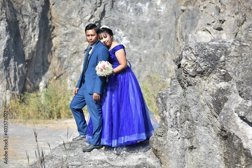 Asian wedding couple at the rocky background