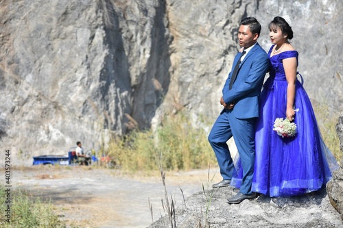 Asian wedding couple at the rocky background