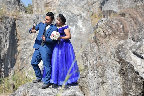 Asian wedding couple at the rocky background