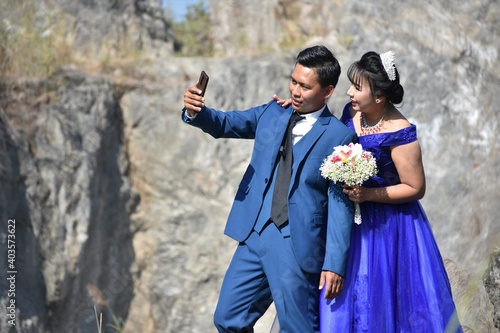 Asian wedding couple at the rocky background