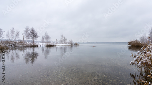 A man goes into a lake in winter for ice swimming