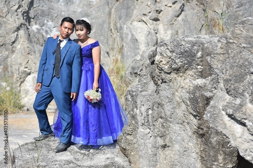 Asian wedding couple at the rocky background