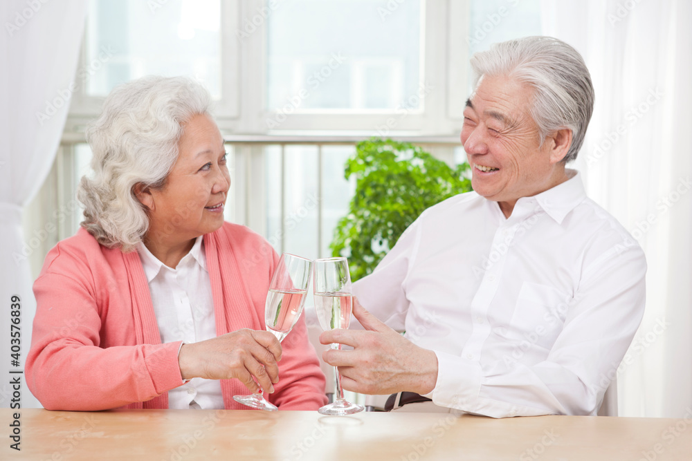 An old senior couple toasting for anniversary An old senior couple toasting for anniversary