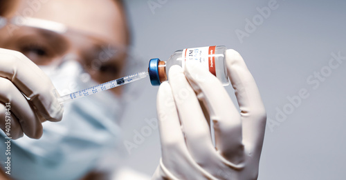 Принти на полотні Doctor holding a syringe with a single bottle vial of Covid-19 vaccine and she is ready for vaccination