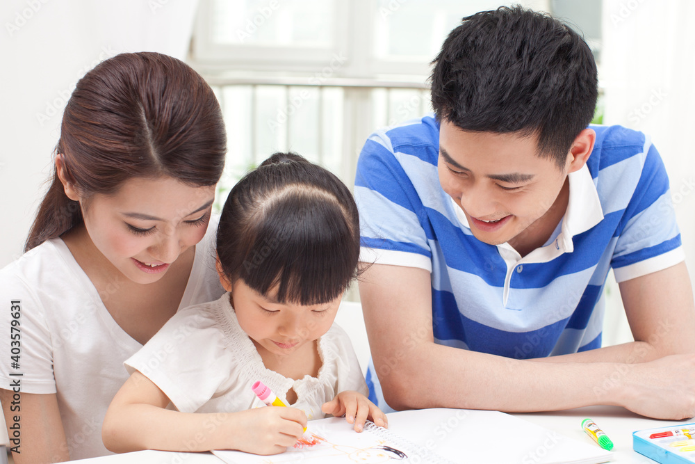 A happy family of three drawing together A happy family of three drawing together