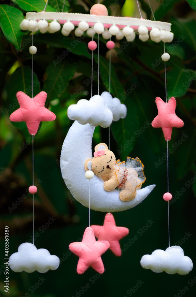 Dreamy baby crib mobile close up hangs over the baby bed cute