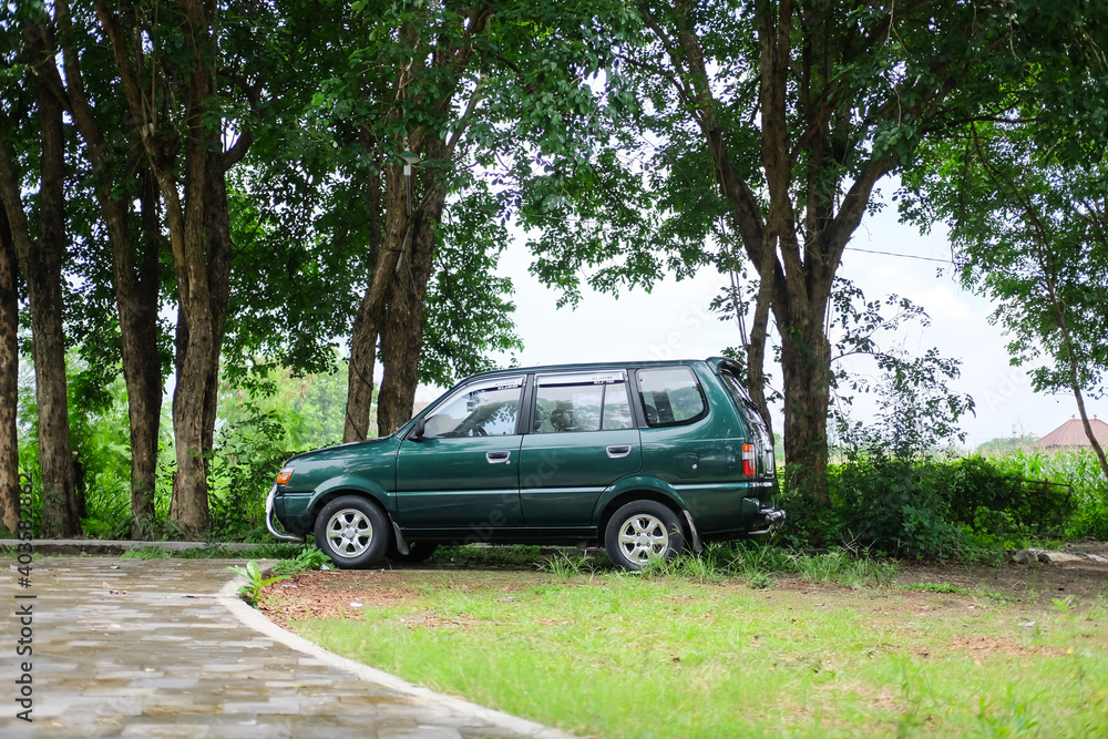 Yogyakarta, Indonesia - December 16, 2020 : an old green car was parked