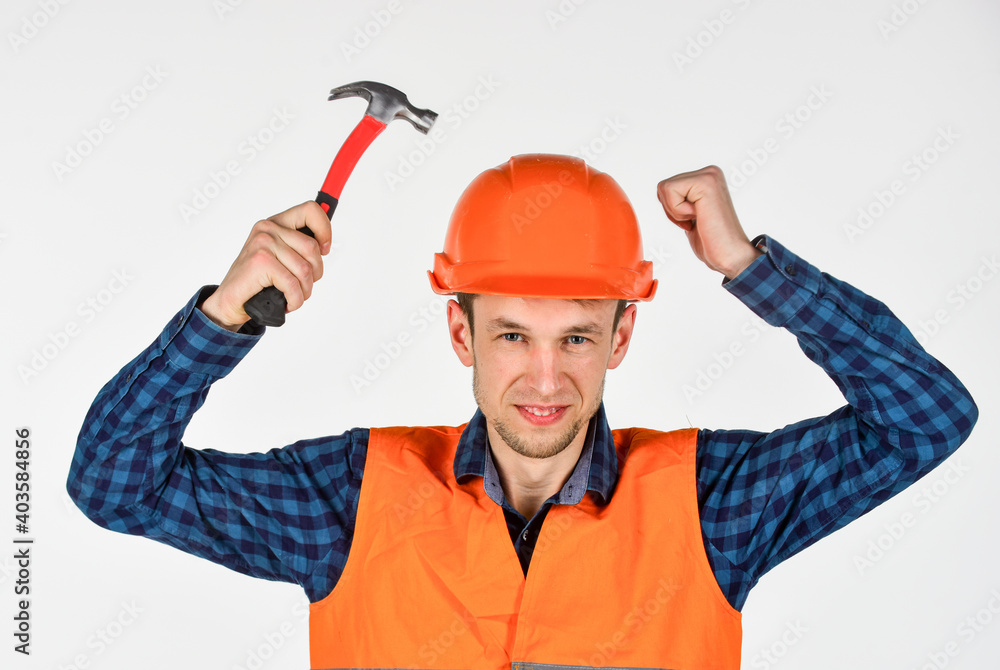 building tool repair equipment. young worker is engineer assistant. repairman in uniform. man work with hammer. real construction worker in helmet. carpenter ready to work