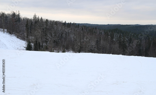 Skiing, snowboard down the hill, mountains view. Cesis. Winter wonderland scenery with skiing track in Latvia. Winter landscape. Beautiful Nature