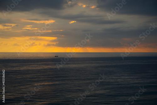 Sailing ship at sea at sunset.