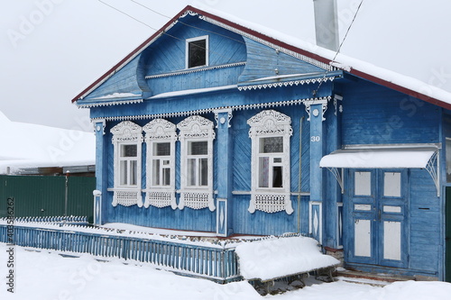 Vintage wooden rural house in Dunilovo village in Ivanovo region, Russia. Building facade; ornamental windows with carved frames. Russian traditional national folk style in architecture. Countryside photo