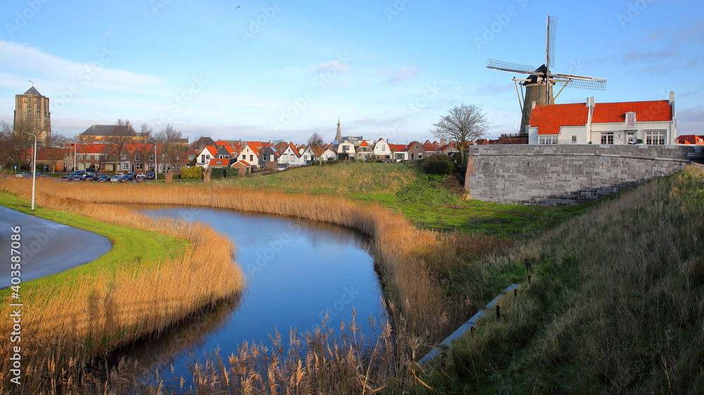 General view of Zierikzee, with the Sint Lievensmonstertoren (Saint Lievens monster church tower)  on the left and a traditionnal windmill on the right, Zierikzee, Zeeland, Netherlands