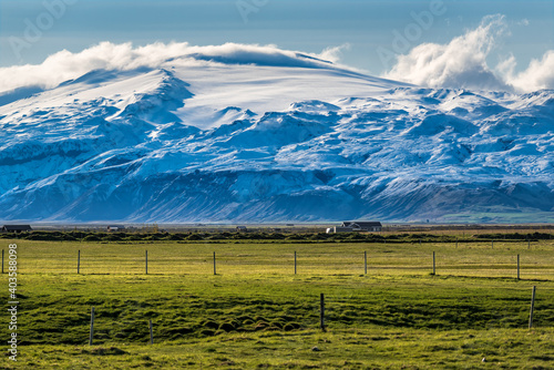 Huge Icelandic glacier and green grass photo