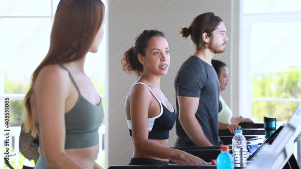 attractive sports women on running treadmill track at fitness gym. attractive sports women on running treadmill track at fitness gym.