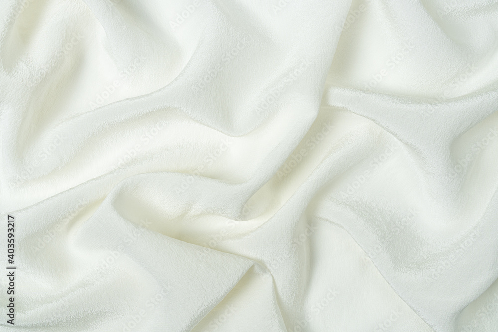 Obraz premium Premium quality white natural silk fabric with waves and folds. Beautiful elegant silk background, top view.