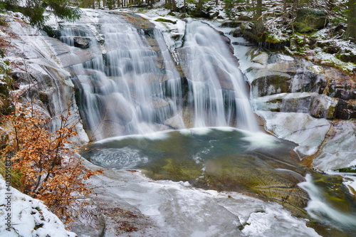Mumlava river in Krkonoše national park. waterfall in winter, snow and ice
